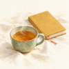 湯気の立つ緑色のカップのお茶と、しおりを挟んだ黄色い表紙の閉じたノートの水彩画